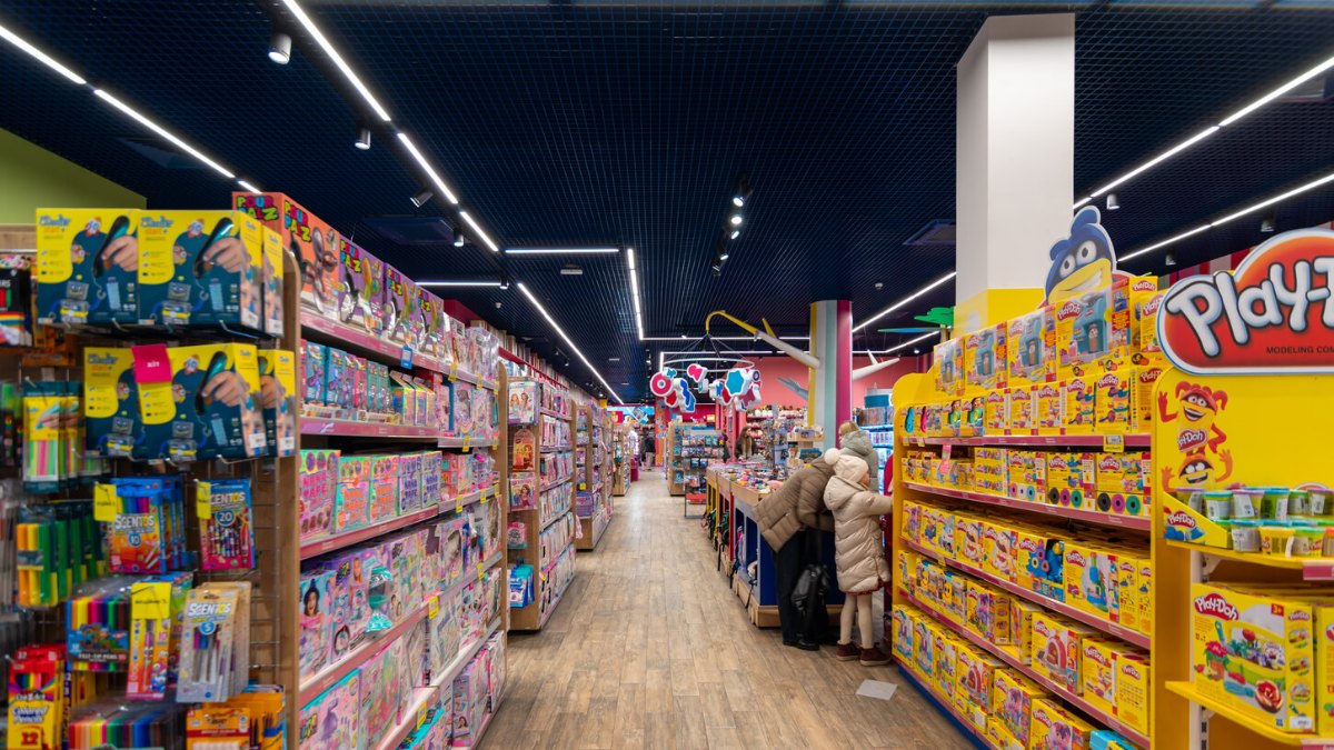Aisle between toy shelves under LINK linear lights