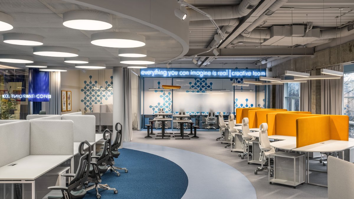 Open-plan IONE GAMES office in Rivne with a curved track and PRIAGO spotlights