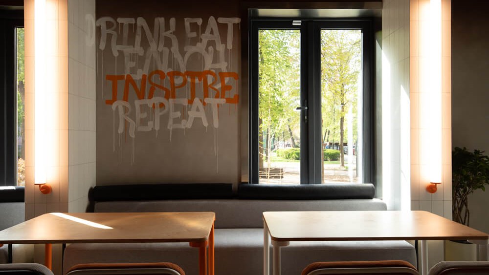 Lettered wall and wall-mounted linear lights at Not Only Wine