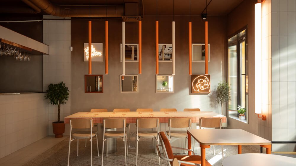Not Only Wine restobar hall in Kyiv with orange WIRE pendants above the tables