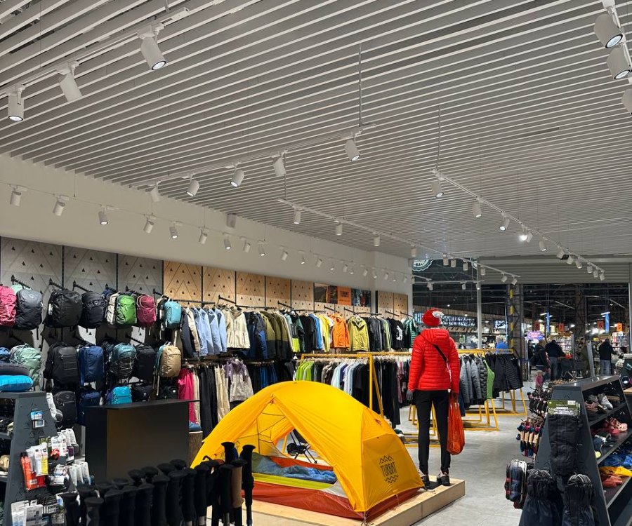 Outdoor clothing racks under PRIAGO track spotlights at Gorgany