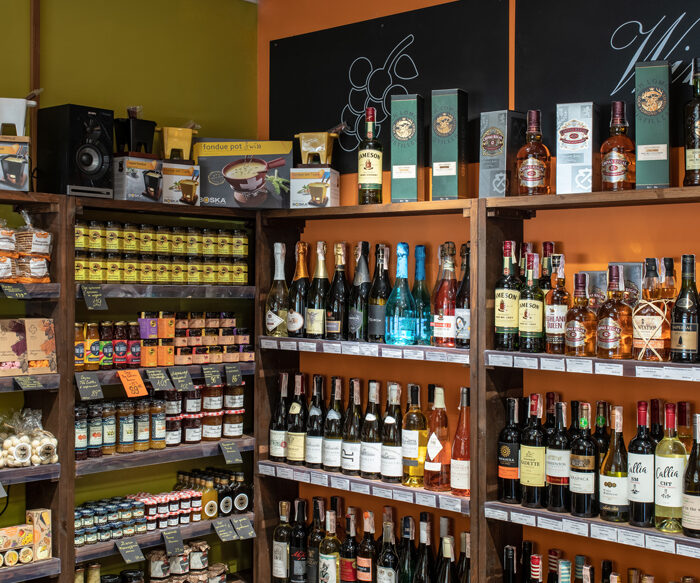 Rack with wine, whisky and groceries in the Cheese Kingdom shop, Kyiv