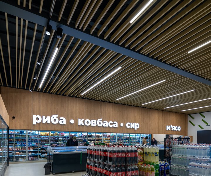 Fish and deli section under LINK linear lights in the slatted ceiling at TENDO