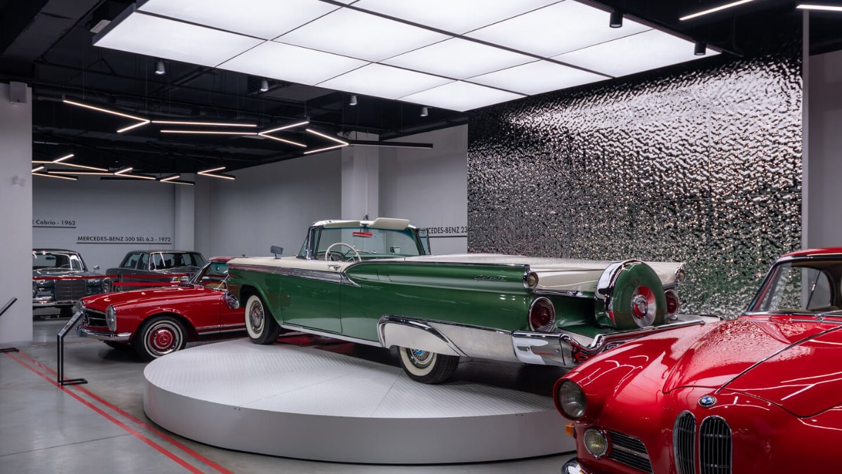 Vintage cars under light panels at the VIKCARS museum in Lviv