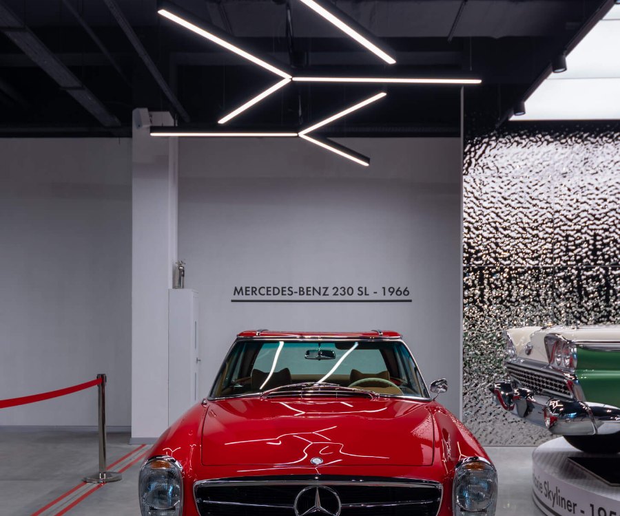 Red vintage car under accent light at VIKCARS