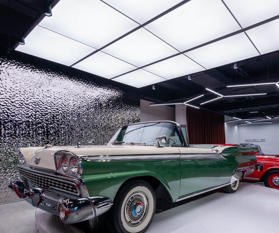 Green convertible under a luminous ceiling at VIKCARS
